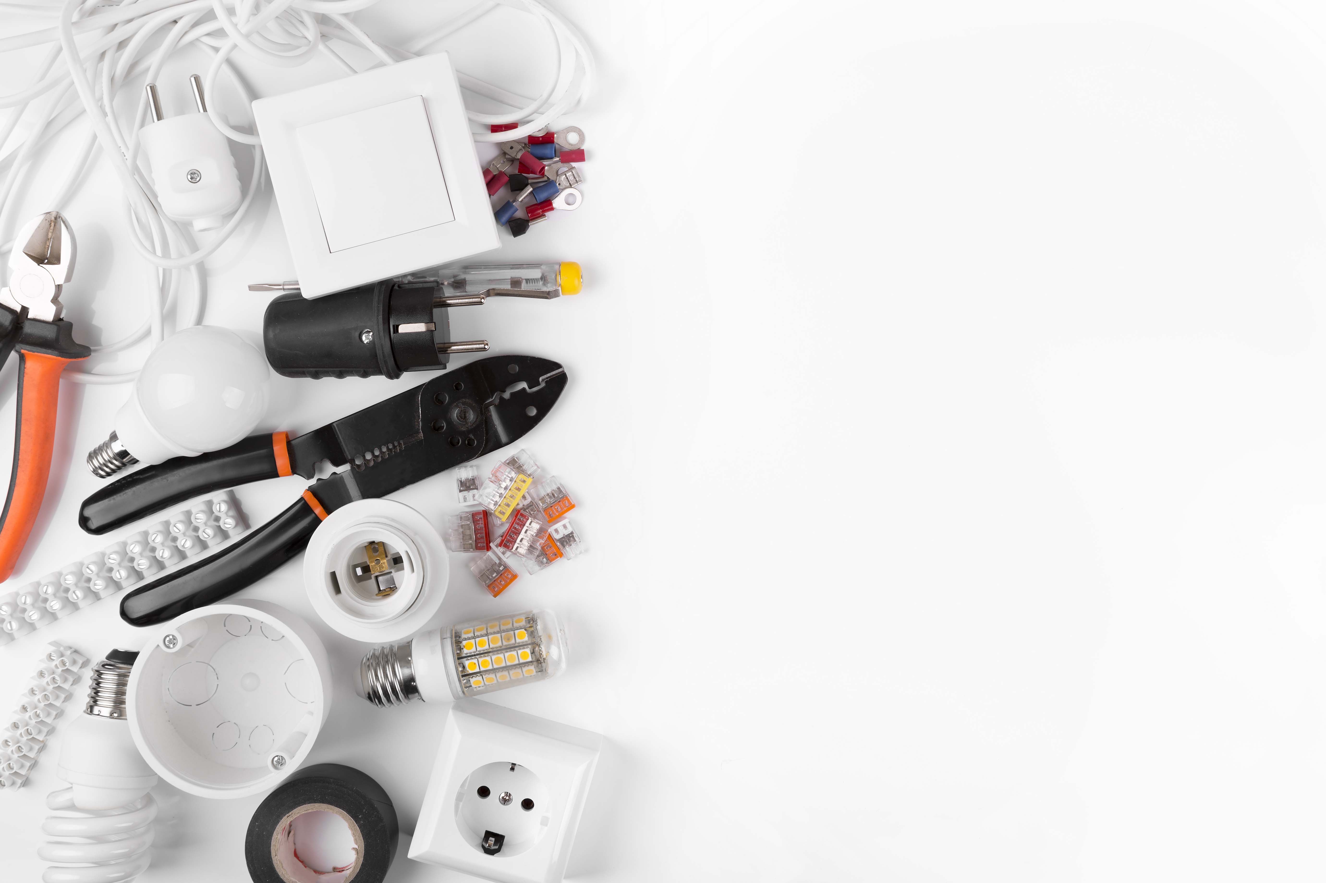 top view of electrical tools and equipment on white